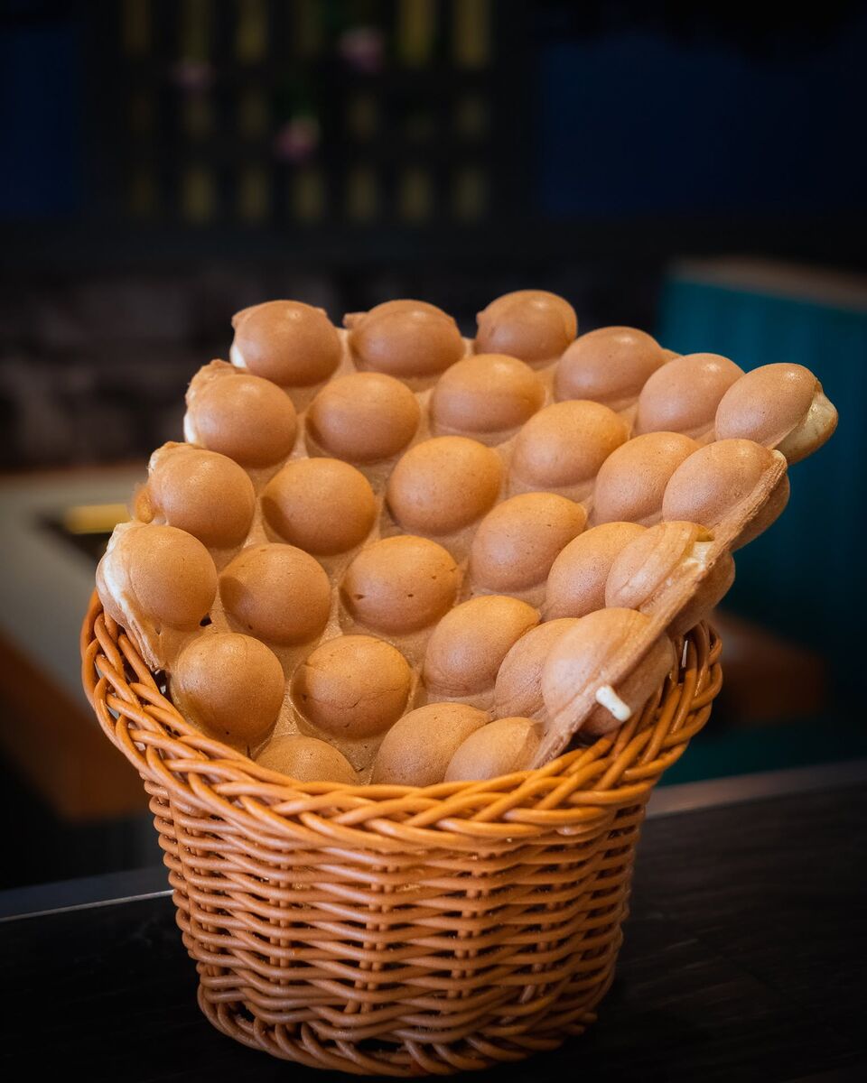 An egg waffle standing in a wicker basket