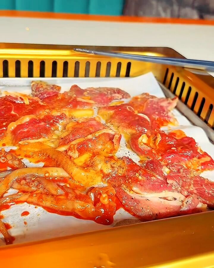 Marinated meat sizzling on the table grill